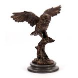 Bronze statue of an owl on a branch