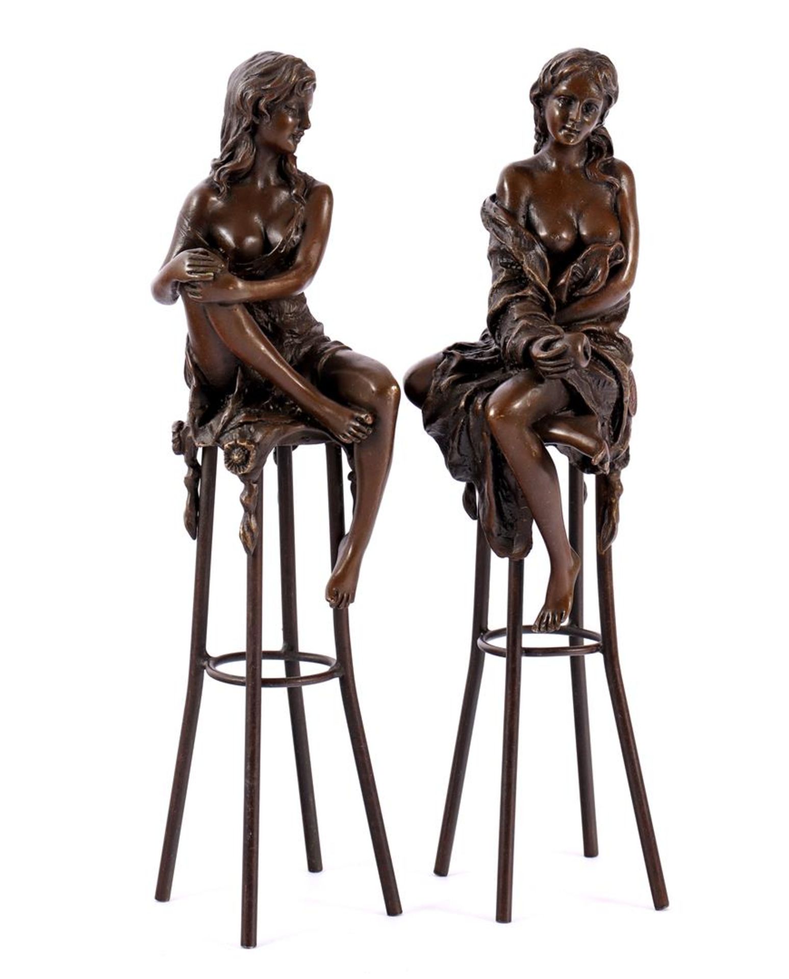 2 bronze sculptures of seated ladies on a stool