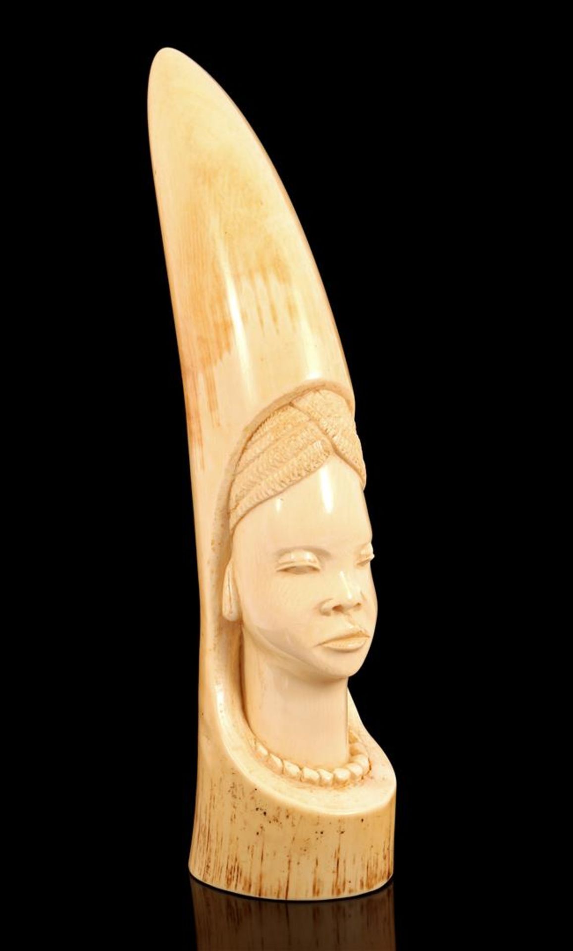 Richly carved ivory decorative object with the face