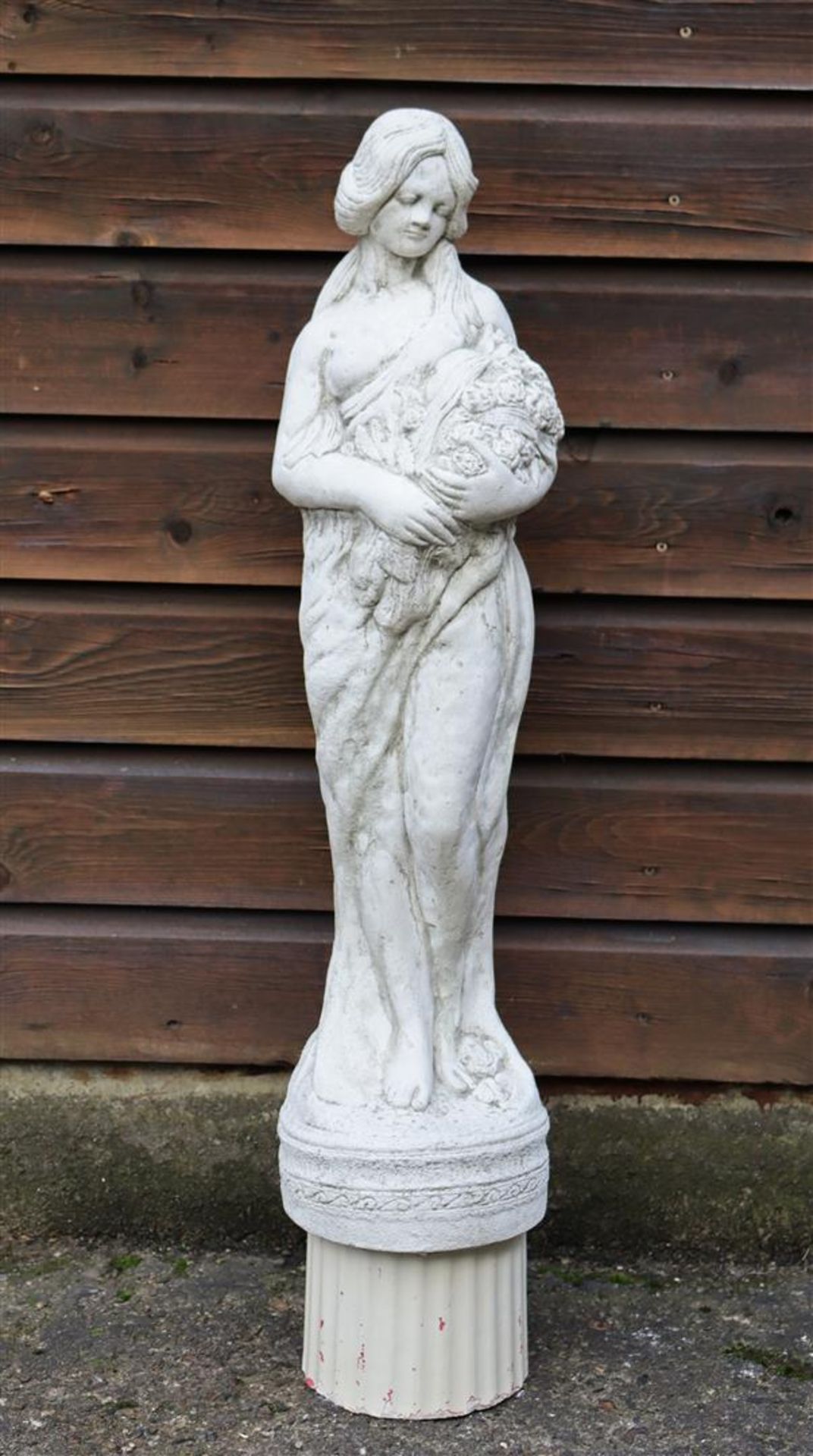Concrete garden statue of woman