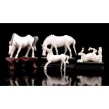 4 carved ivory figurines of horses, 3 of which on a wooden base, China ca.1920, largest 6.5x7.5x3 cm