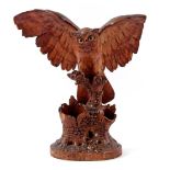 Wooden bombarded statue of an owl