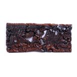Carved ebony wall relief depicting a dragon with person, Java ca.1950, 23x50 cm