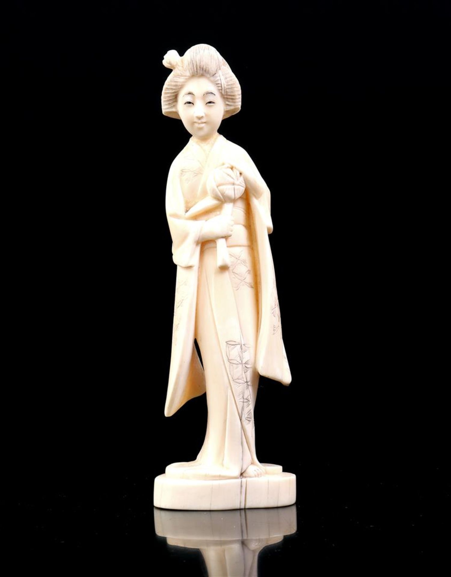 Carved ivory Okimono of a lady with flower in her hand, China ca.1880, 16 cm high, 138 grams. With c