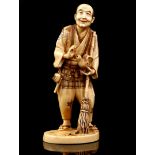 Carved ivory statue of a standing man with bird and broom, Japan, Meiji Period ca.1880, 18 cm high,