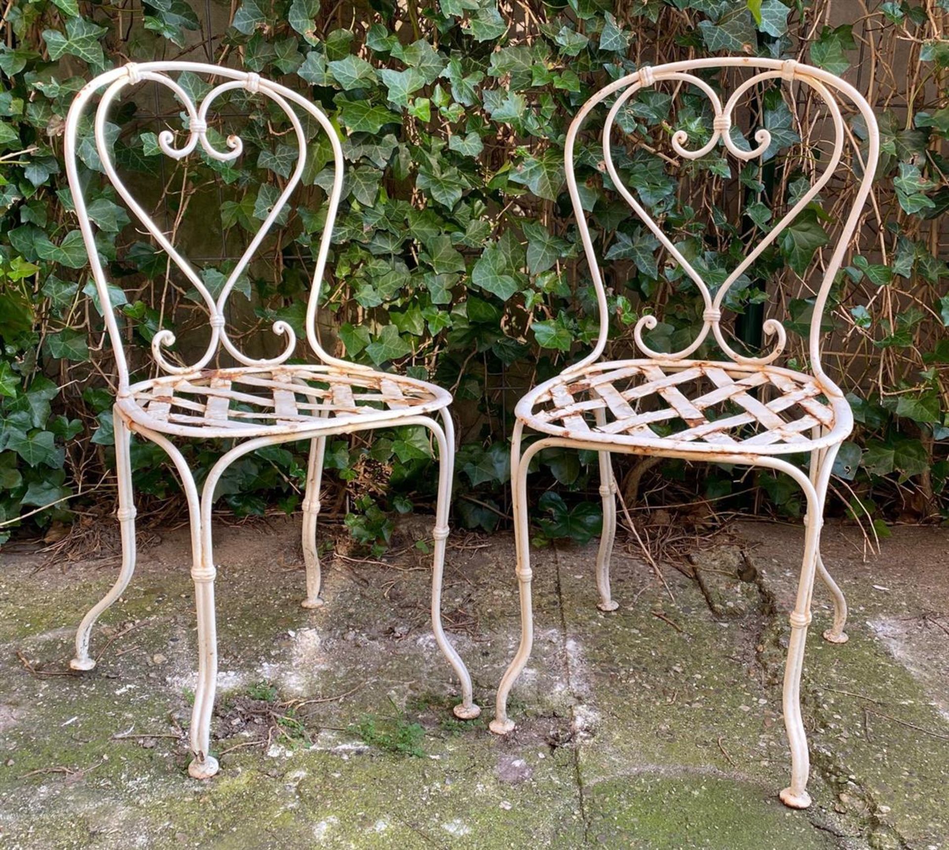 2 old wrought iron bistro chairs