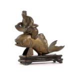 Bronze 2-part statue of a Chinese man on a koi carp standing on a wooden base, 18 cm high