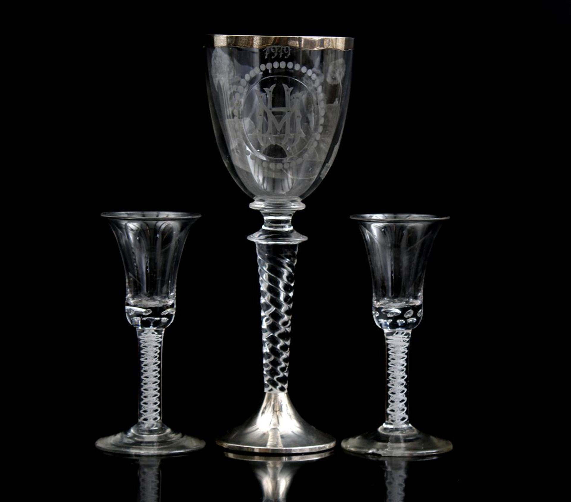 Etched glass goblet with monogram HM and decoration of bridge, dated 1919, on twisted stem, and 2 En