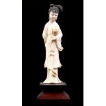 Carved ivory statue of a woman with a flower in her hand, China ca.1920, 15 cm high, 74.4 grams. Wit