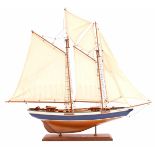 Wooden scale model sailing boat on stand