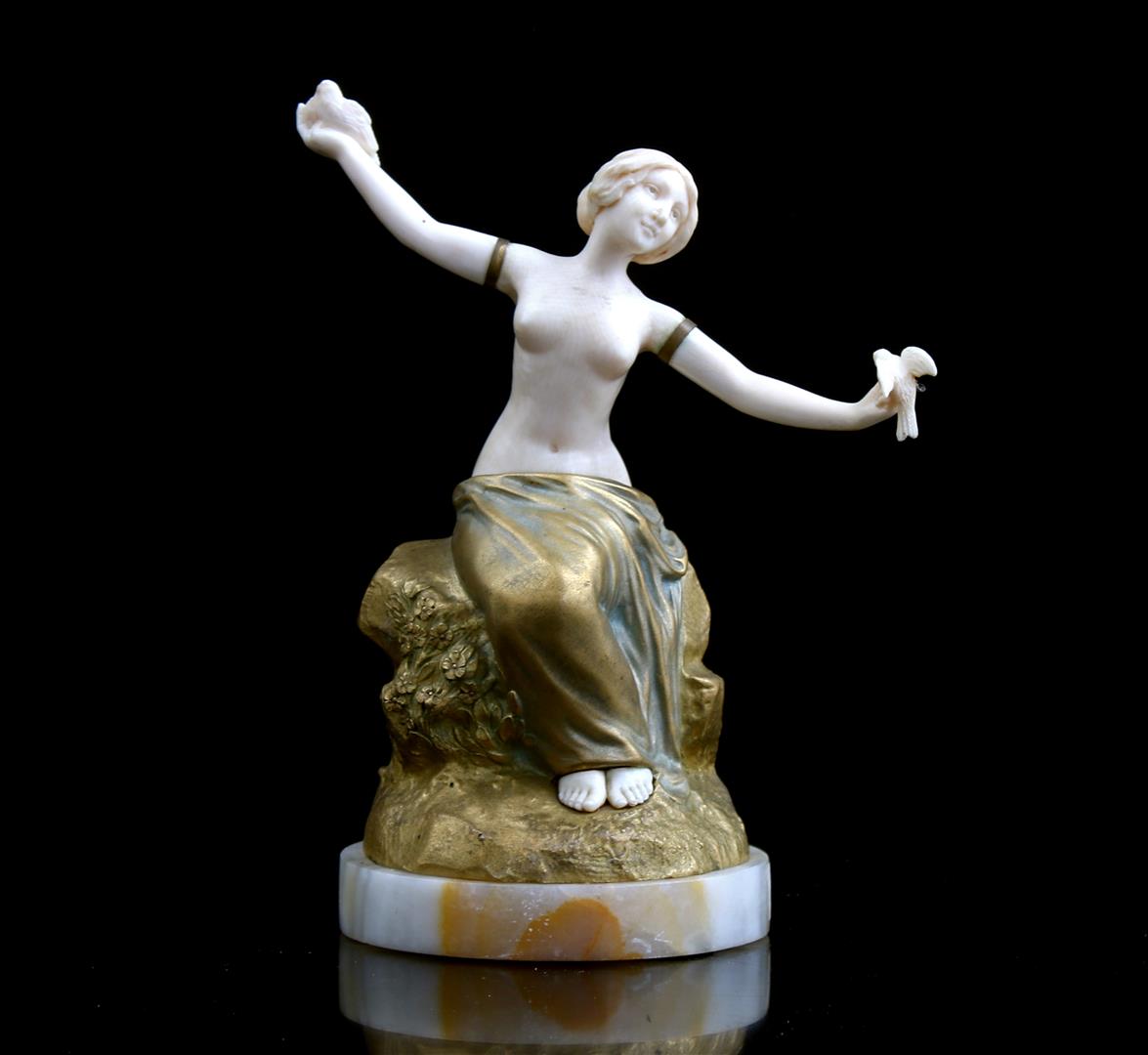 Unmarked, bronze sculpture with carved ivory of a woman with birds on her hands, France ca.1890, 19.