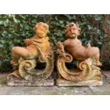 2 sandstone statues of putti 75 cm high, 54 cm wide