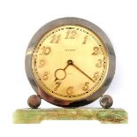 Marked C. Bucherer, Art Deco 8 days round metal table clock with quartz Swiss movement, on onyx base