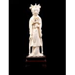 Carved ivory figurine of a standing woman with a flower in her hand, China ca.1920, 12 cm high, 38.6