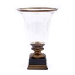 Glass goblet on marble with bronze base