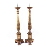 2 wooden gold colored candlesticks