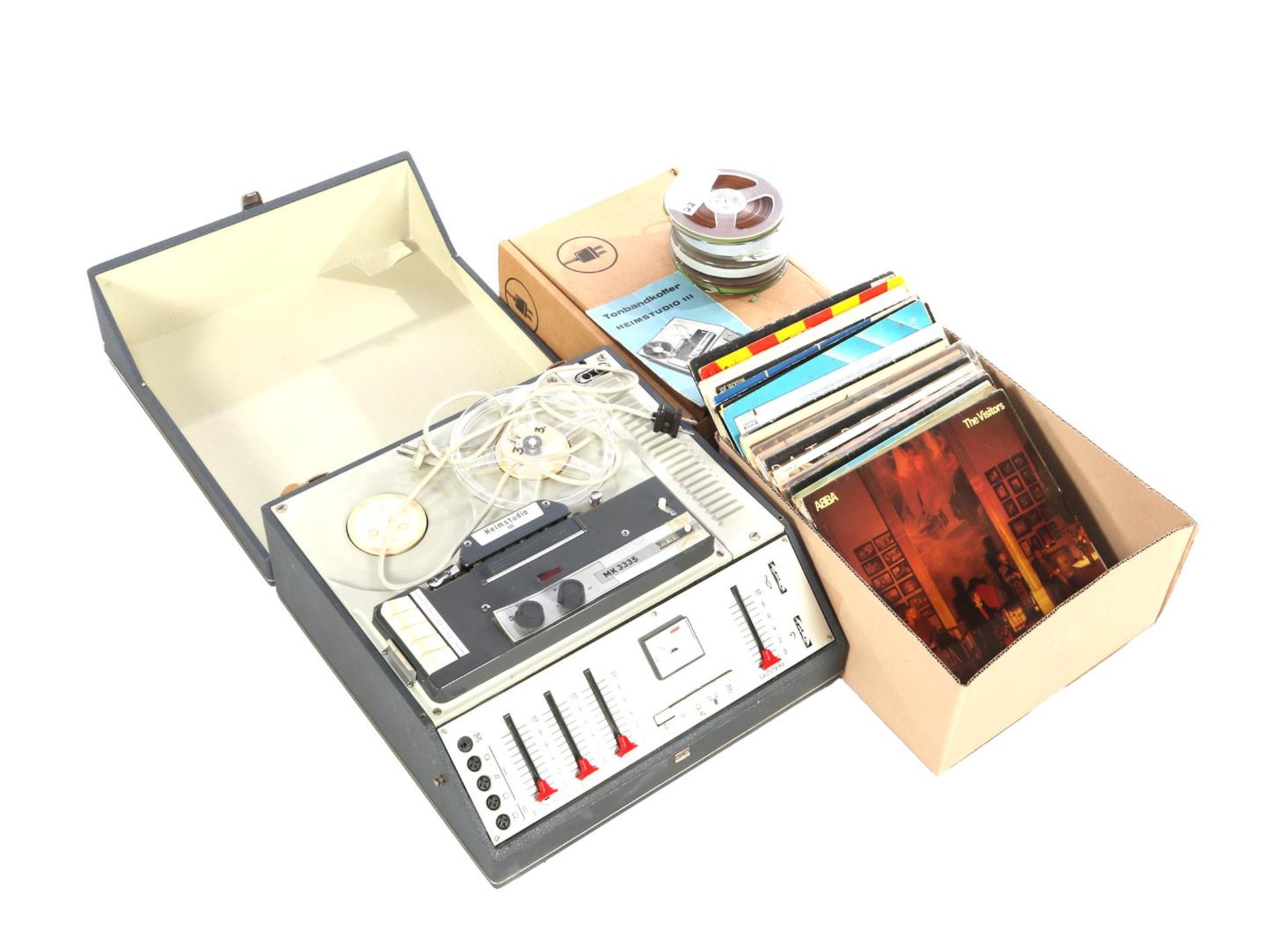 Tape recorder and stack of LPs