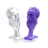 2 plastic purple and silver colored busts