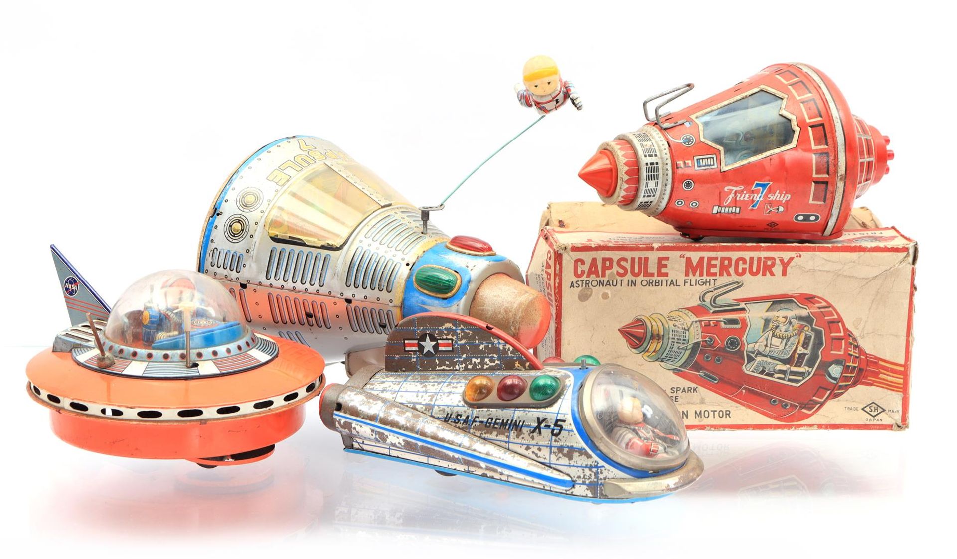 4 tin toy space vehicles