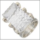 A 1970s style rock crystal and silver ring, set with a rectangular fancy-cut stone within angular