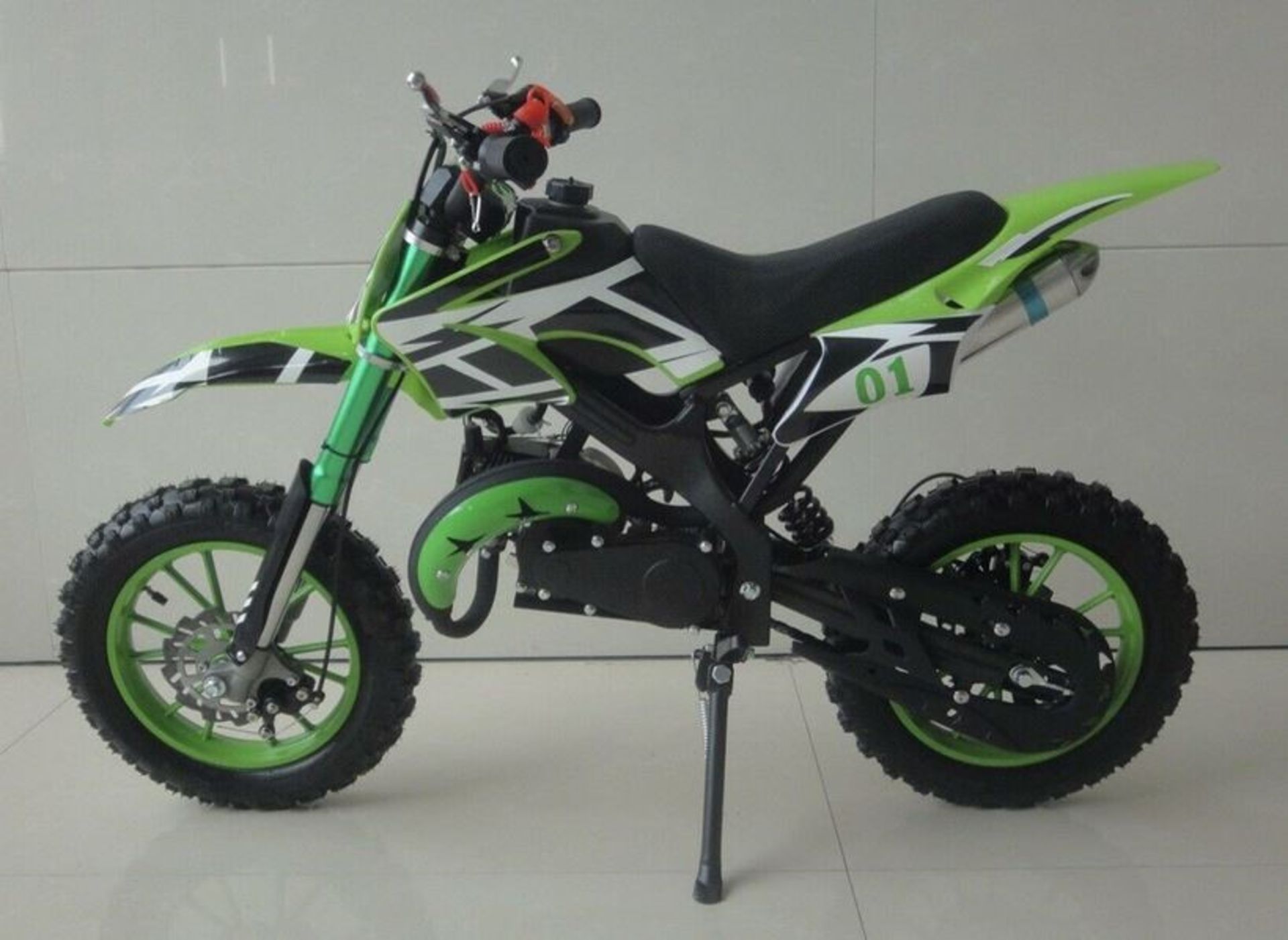 1 LOT TO CONTAIN AN AS NEW BOXED FALCON KIDS 49CC MINI DIRT BIKE IN GREEN, FULL FRONT AND REAR