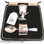 Three piece cased christening set, egg cup, napkin ring, egg spoon. Sheffield 1927.