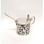 A Birmingham silver mustard dated 1909 complete with blue liner and a silver spoon. 6 cm height, 8