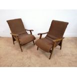 Pair of mid century easy chairs having cast iron frame and sprung seat. Raised on tapering supports.