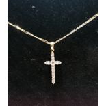 12 ct and diamond crucifix on a 9 ct curb chain (0.45 cts diamonds).