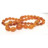 An amber style strand of beads. 96 cm length approx.