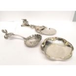 Two late 19th century caddy spoons together with a golfing trinket. 60 gms approx.