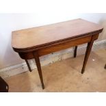 A 19th century mahogany flip top table having a moulded top raised on tapering supports (a.f). 102