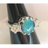 Fine 0.750 (18ct) black opal (Lightening Ridge) and diamond dress ring. The diamonds 2 x 0.55 cts