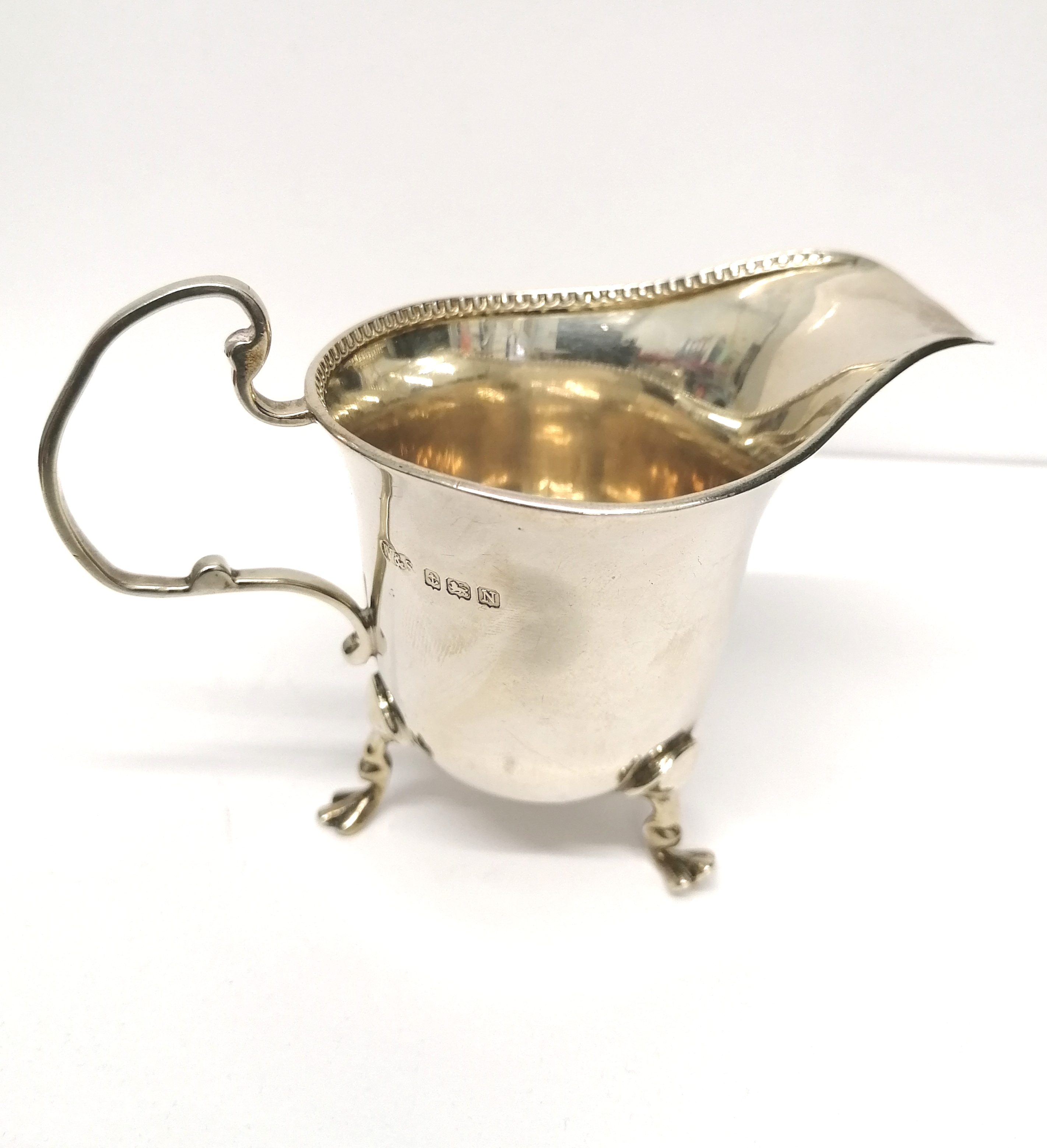 A Birmingham silver cream jug dated 1937 by Wilson and Sharp Ltd. 8 cm height, 11 cm width approx.