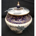 A Royal Doulton US Patent blue and white biscuit barrel. Repair to finial. 19cm in height by 15.