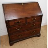 A 19th century oak bureau having a fitted interior over short and two drawers. Raised on bracket