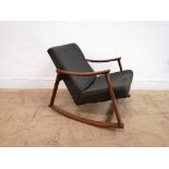 A mid century rocking chair in the Danish style having padded back support and seat. Upholstered