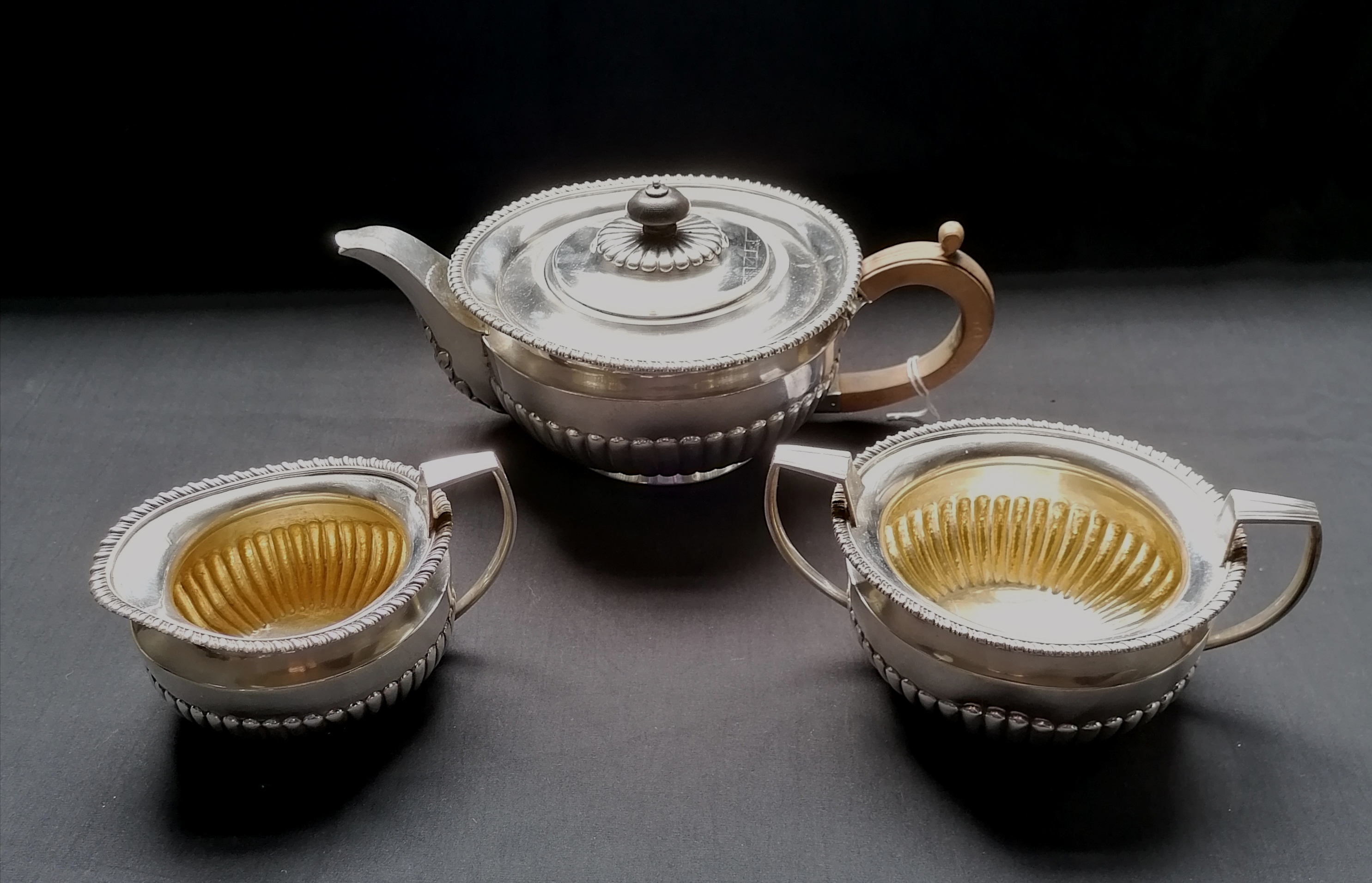 Three piece silver ovoid half lobed tea set with gadroon decoration. London 1919, makers Daniel &