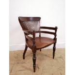 A 19th century mahogany office chair having a splat back and carved arm rests above moulded seat.
