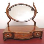 A 19th century inlaid mahogany dressing mirror having an oval mirror over three short drawers.