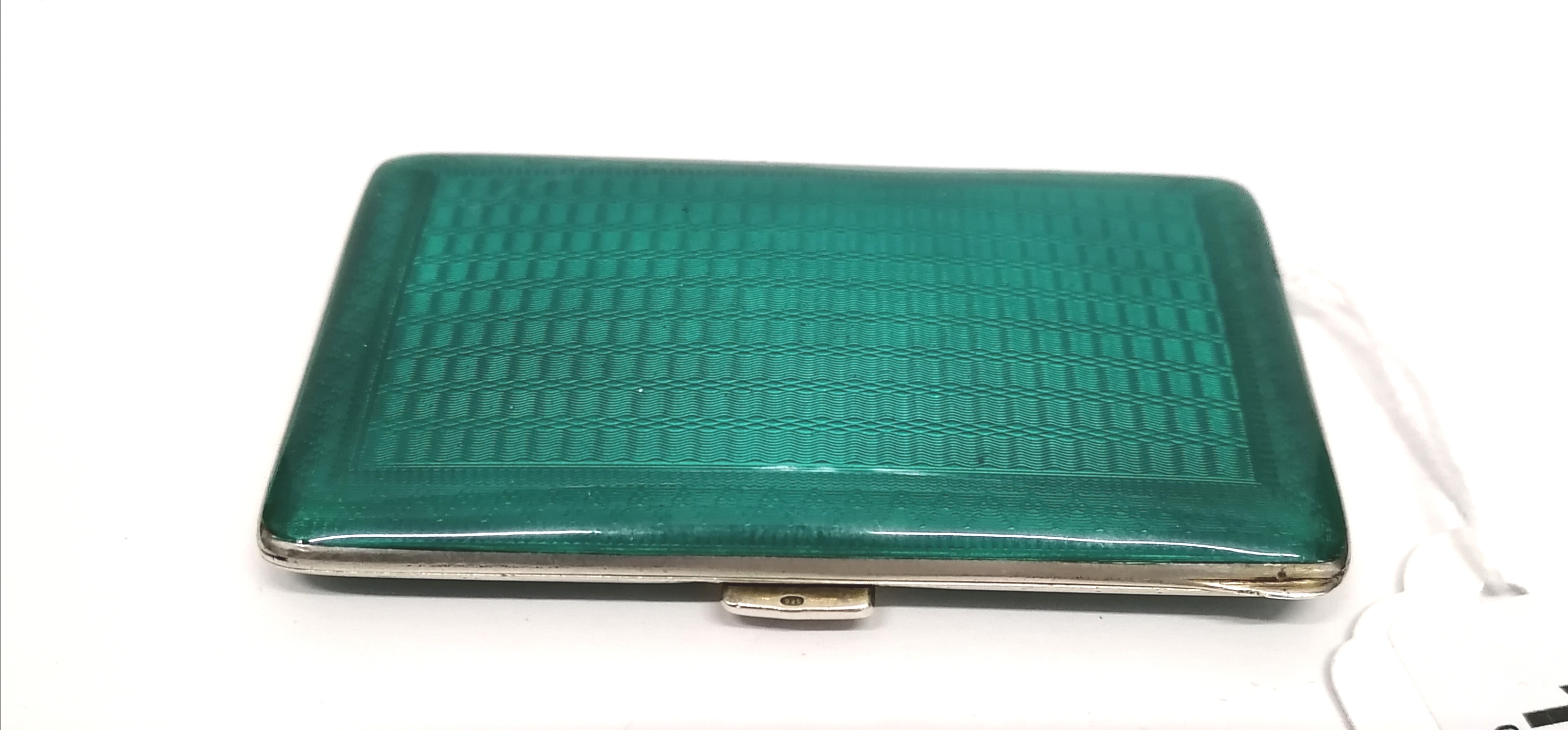 An art deco silver gilt and green enamel ladies cigarette case. 8.5 cm width approx (a.f).