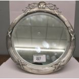 A late 19th, early 20th century framed London silver mirror having a circular form with bevelled