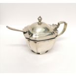 A London silver mustard dated 1933 complete with blue liner and matched spoon. 6.5 cm height, 8.5 cm