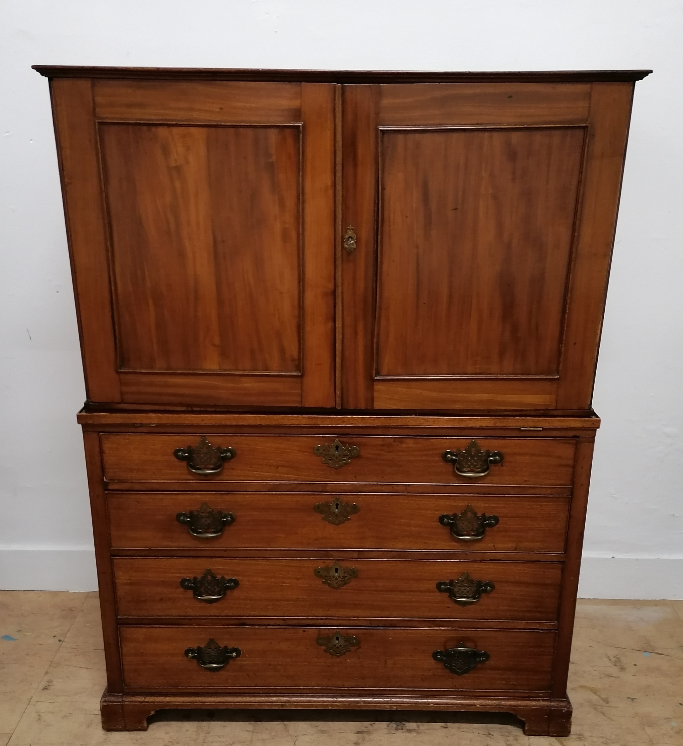 A 19th century mahogany seaman's chest having removable linen press to top revealing writing slope