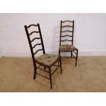 A pair of Edwardian mahogany ladder back side chairs having padded seat raised on turned support.