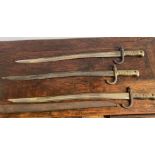 THREE ANTIQUE FRENCH BAYONETS WITH ONE ASSOCIATED SCABBARD, 70cm long