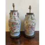 TWO PANEL DECORATED PINK & GREEN GLAZED FAMILLE ROSE PATTERNED TABLE LAMPS ON CARVED WOODEN BASES
