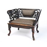 CARVED HARDWOOD AND UPHOLSTERED LOW ARMCHAIR LATE QING DYNASTY the openwork arms carved with