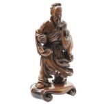 CARVED HARDWOOD FIGURE OF A SCHOLAR QING DYNASTY, 19TH CENTURY the standing figure wearing a long