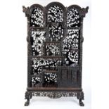 IMPRESSIVE CARVED HONGMU DISPLAY CABINET QING DYNASTY, 19TH CENTURY the arched top above an